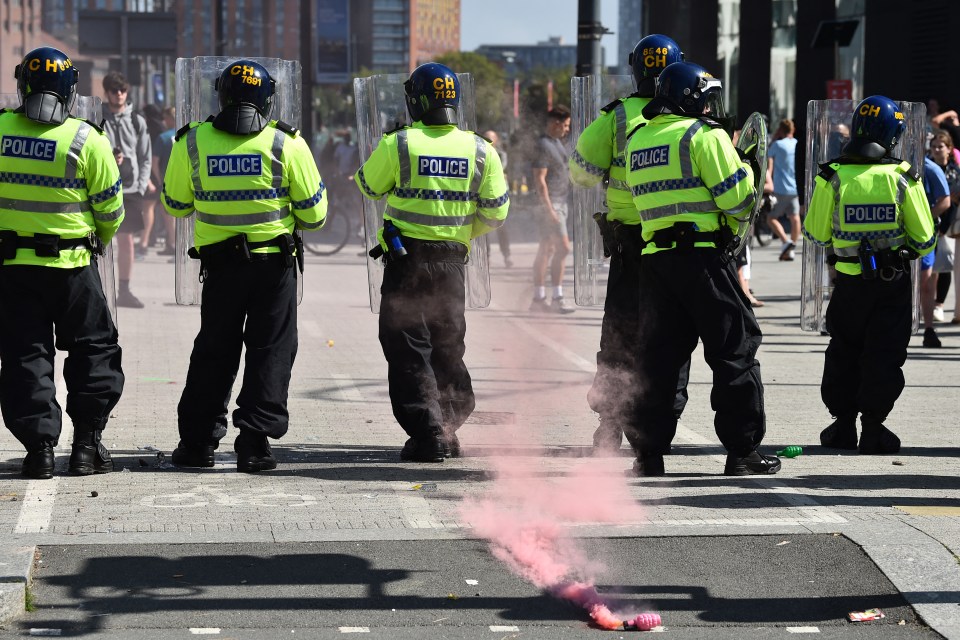 a group of police officers standing on a street