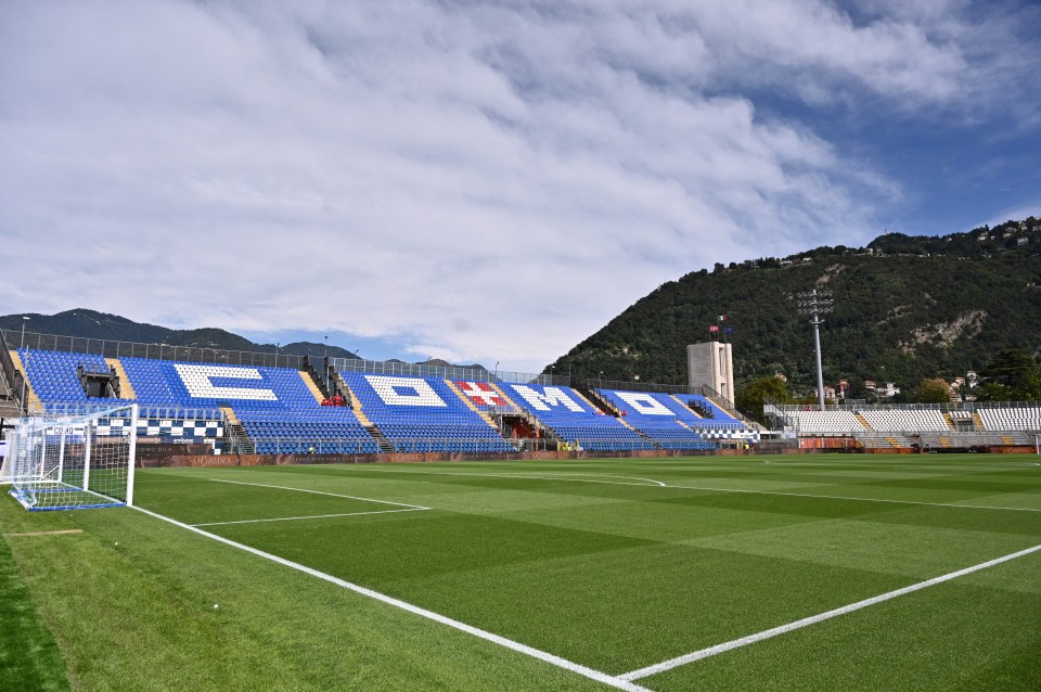 a soccer field with the word como painted on the seats