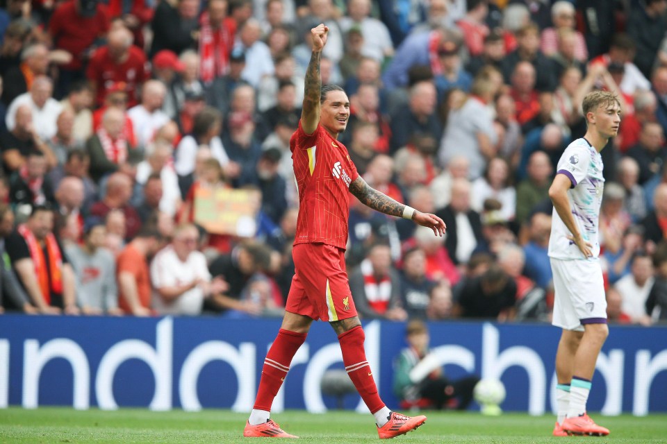 a soccer player wearing a red jersey with the word liverpool on it