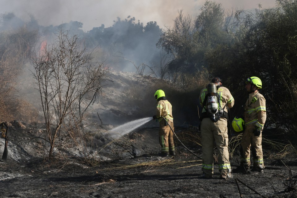 Responders put out a fire in the area of Lod, near Tel Aviv, in central Israel after the missile was fired from Yemen