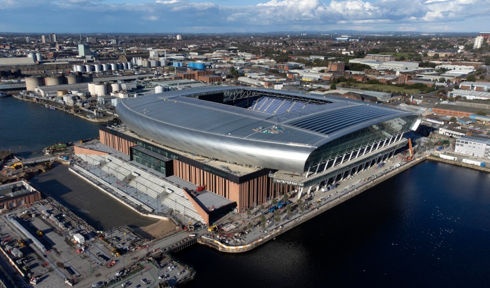 an aerial view of a large stadium in the middle of a body of water