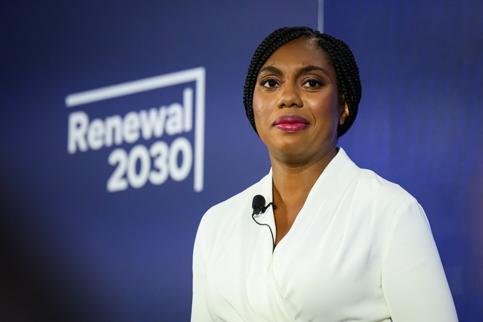 a woman stands in front of a sign that says renewal 2030