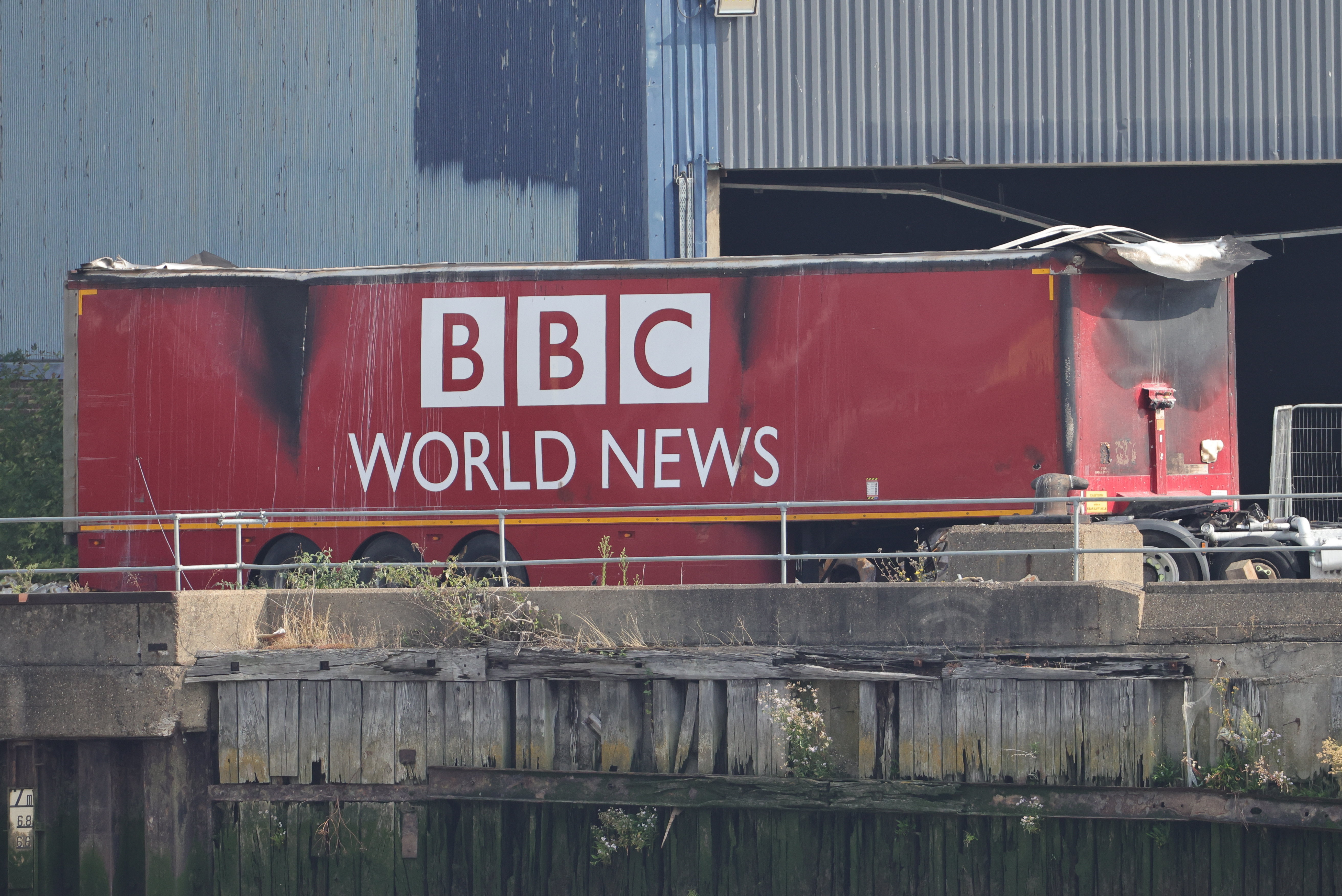 The remains of a fire damaged BBC World News lorry on the film set