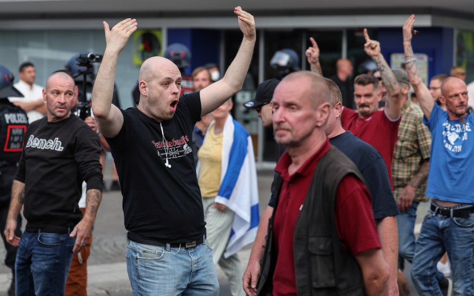 A far-right mob gather at a demonstration in Solingen last month