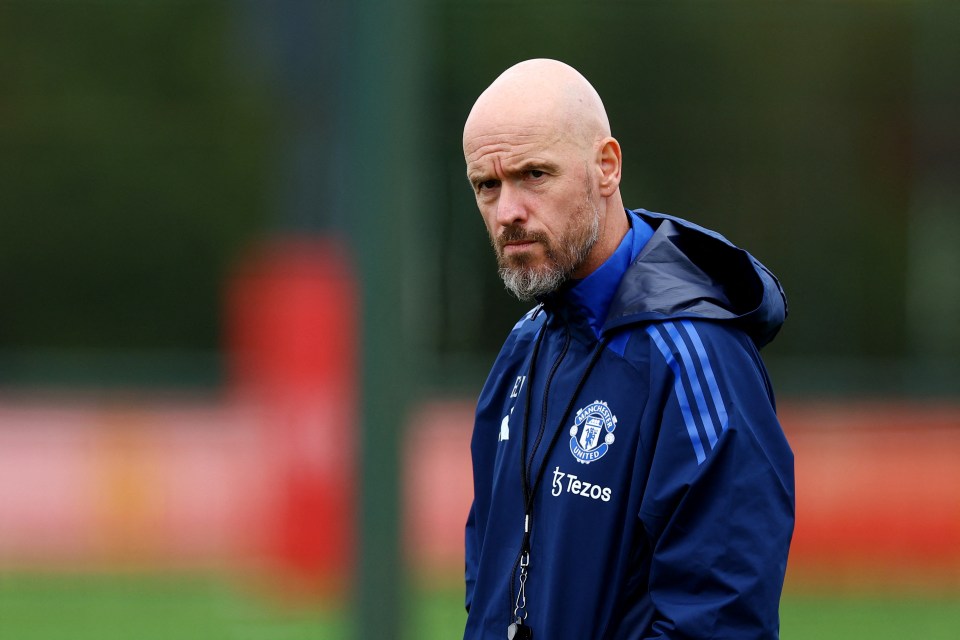 a man wearing a blue manchester united jacket