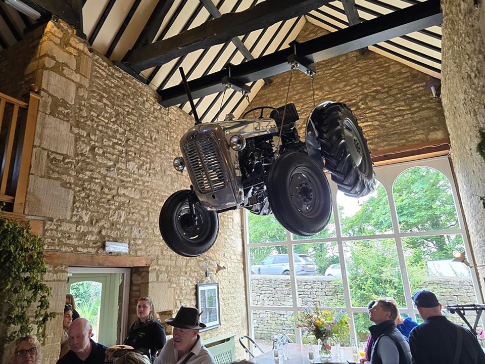 a tractor is hanging from the ceiling of a building