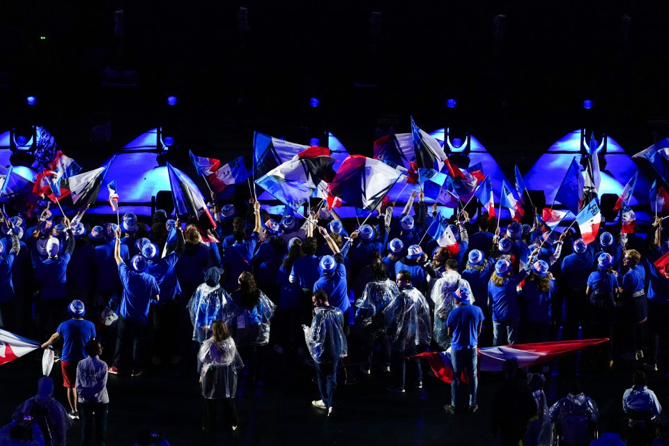 a group of people holding flags with one wearing a shirt that says ' a ' on it