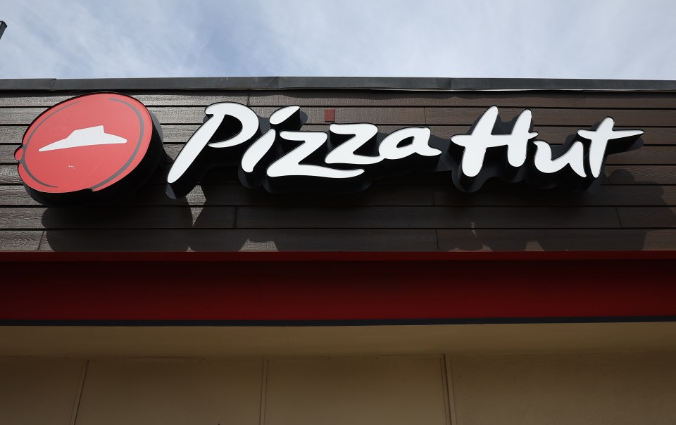 a pizza hut sign on the side of a building