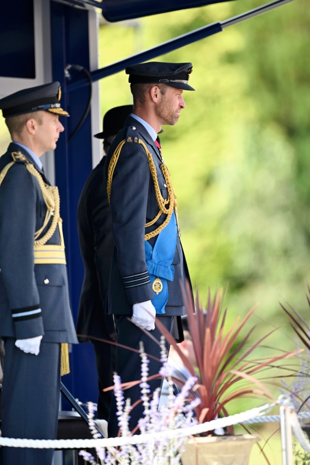 a man in a military uniform has a blue medal around his neck