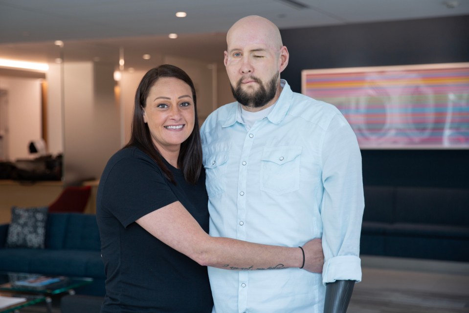 a man with a prosthetic arm stands next to a woman