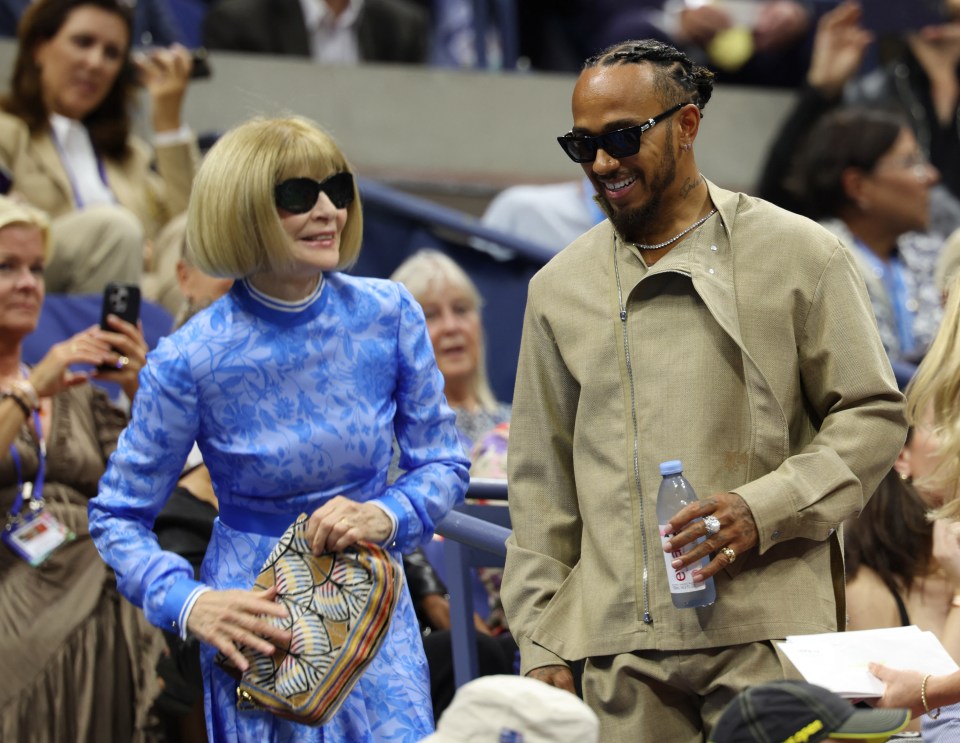 a man holding a bottle of aquafina water next to a woman in a blue dress