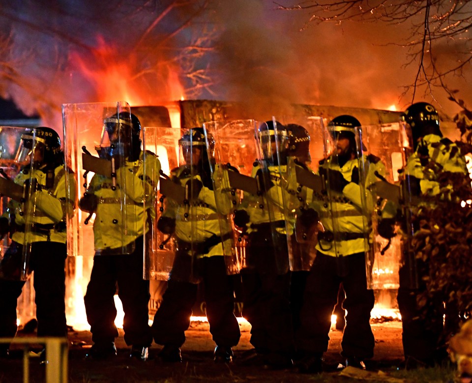 Riot police outside the Suites hotel in February 2023