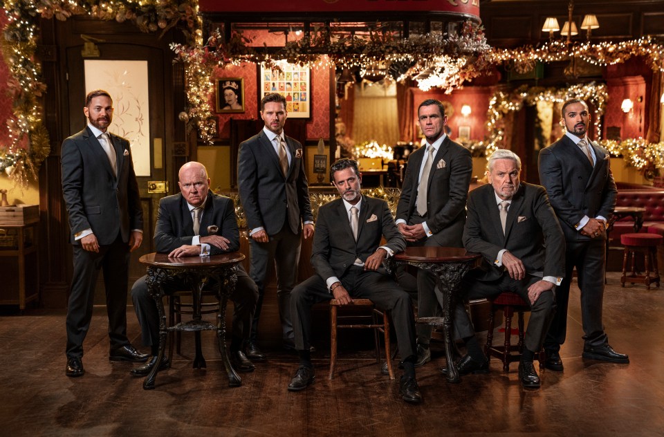 a group of men in suits are posing for a picture