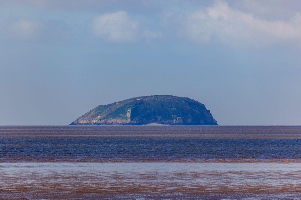 a large rocky island in the middle of the ocean