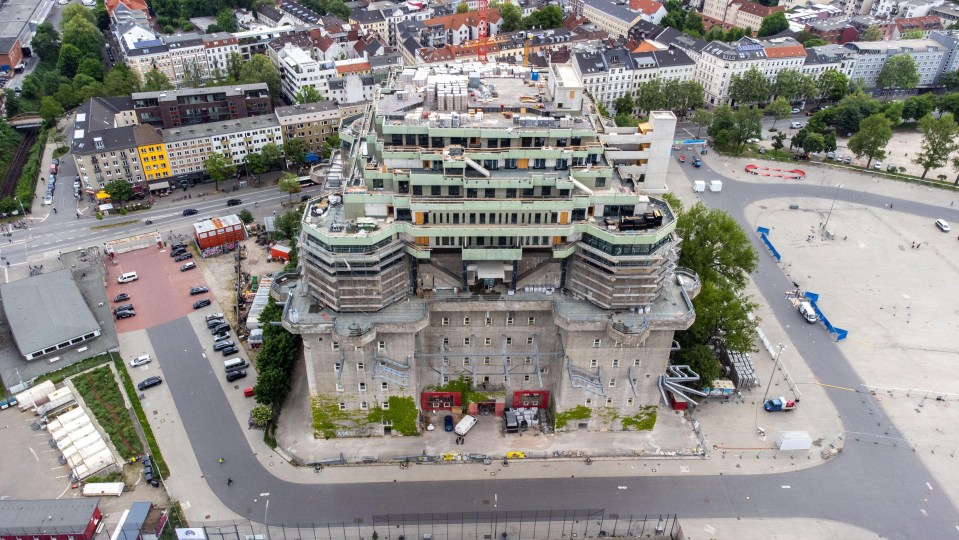 an aerial view of a large building with stairs leading up to the top