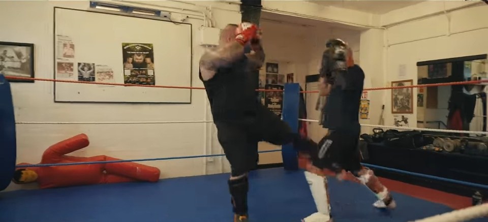 a boxing ring with a poster on the wall that says ' boxing ' on it