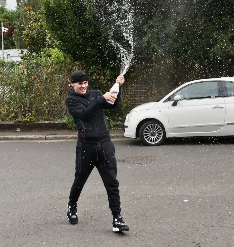 A lag spraying champagne as he walked free from HMP Wandsworth yesterday