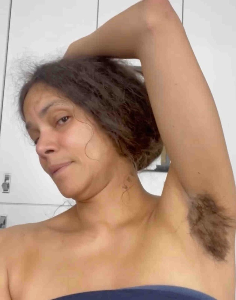 a woman without a shirt has a hairy armpit