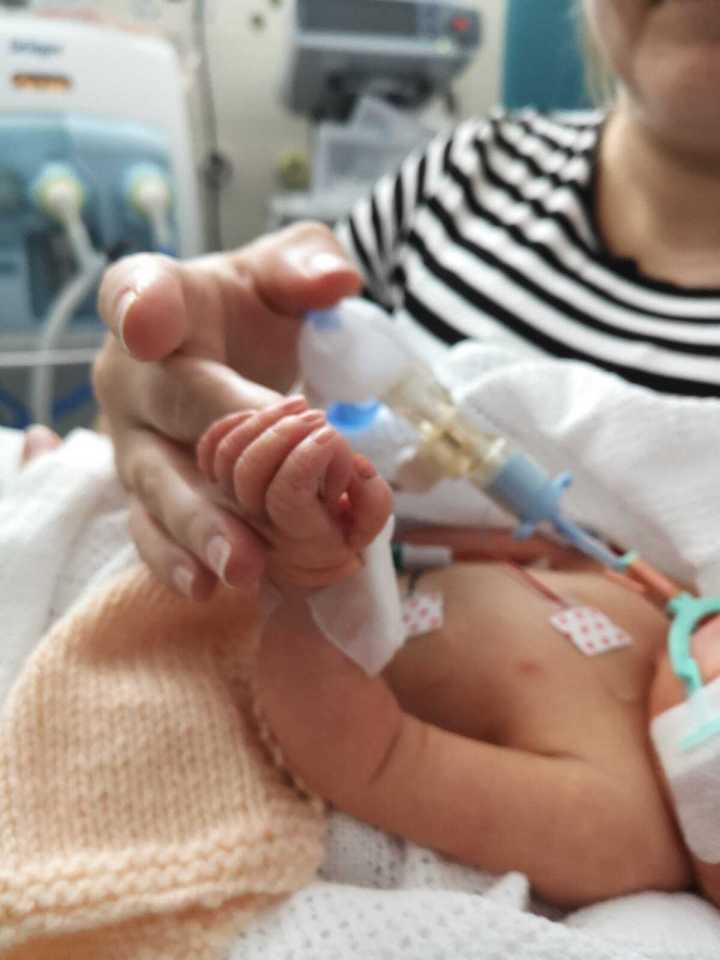 Keira, from Abertillery, Monmouthshire, holding little Mali's hand