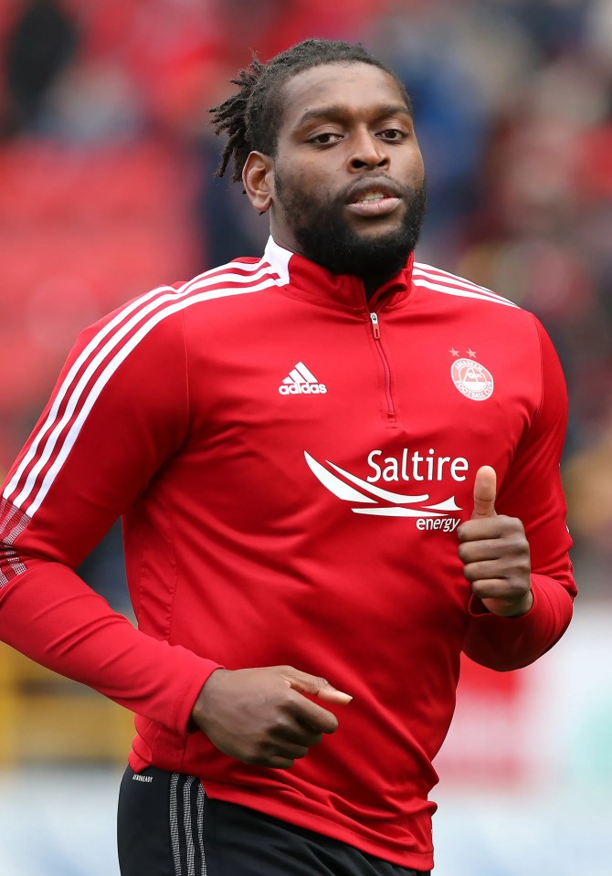 a man wearing a red shirt that says saltire energy