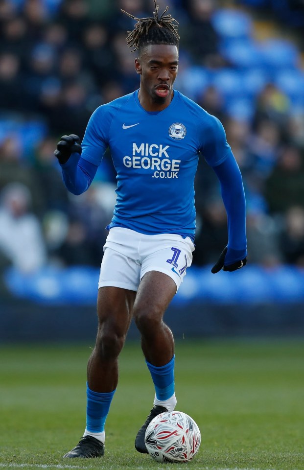 a soccer player wearing a blue shirt that says mick george