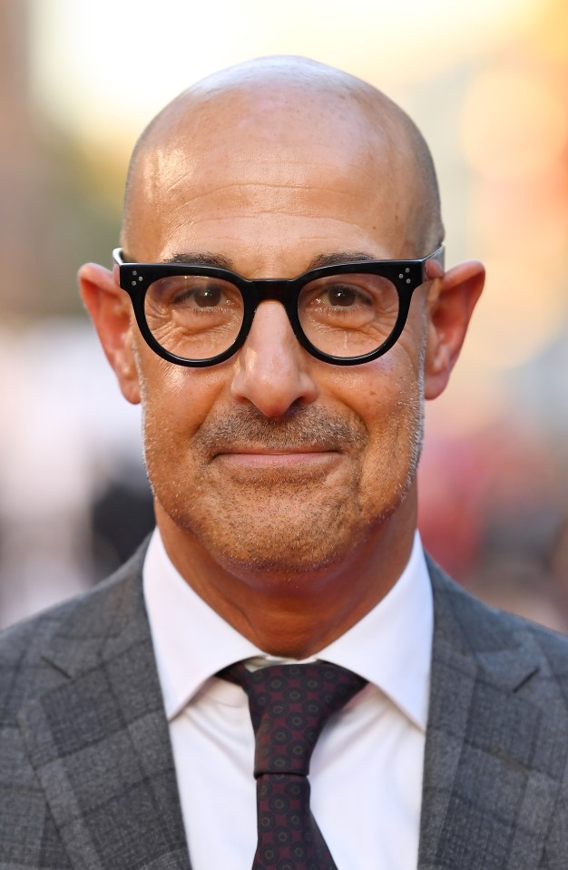 a bald man wearing glasses and a suit and tie