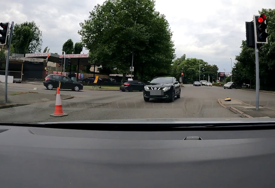 A Nissan SUV blew through a red light before switching to the wrong side of the road