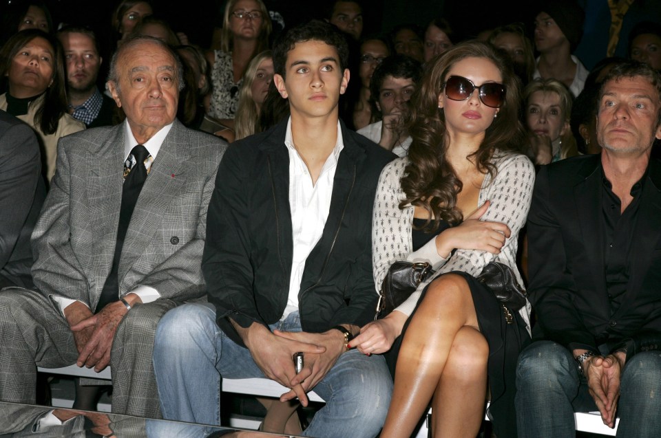 a group of people sitting in a row at a fashion show