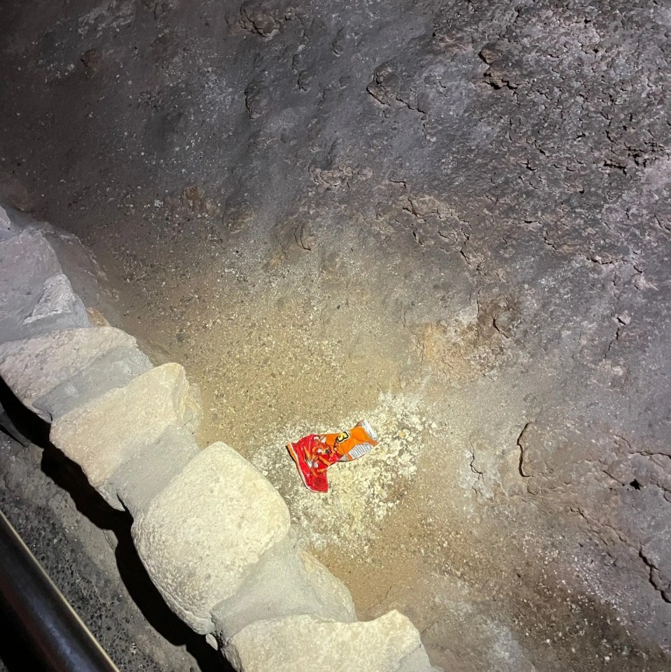 a piece of bread is laying on the ground in a cave