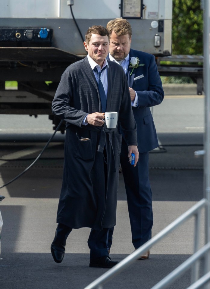 a man in a robe is holding a coffee mug that says ' e-mail ' on it