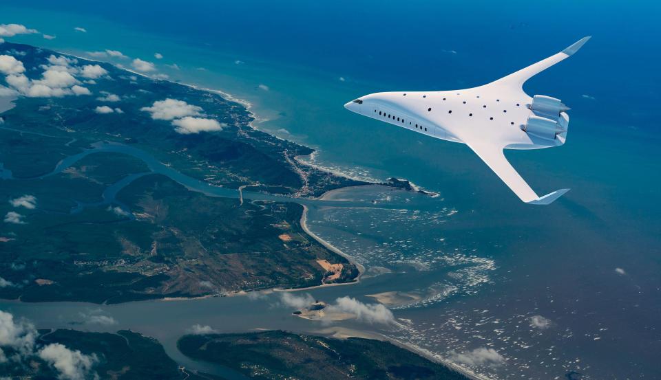 a white plane is flying over a body of water