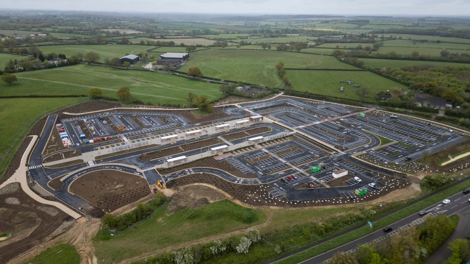 an aerial view of a large parking lot surrounded by fields