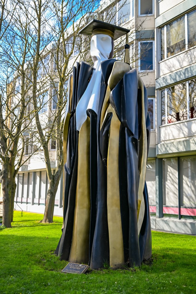 a statue of a man in a graduation cap and gown