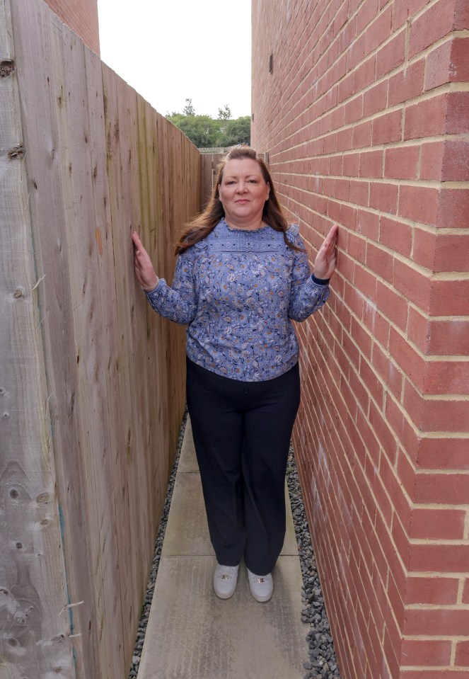 a woman leaning against a brick wall with the words north on the bottom