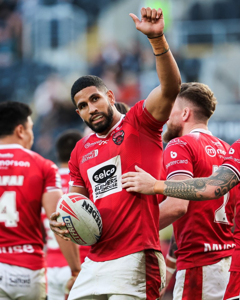 a rugby player wearing a red shirt that says selco on it