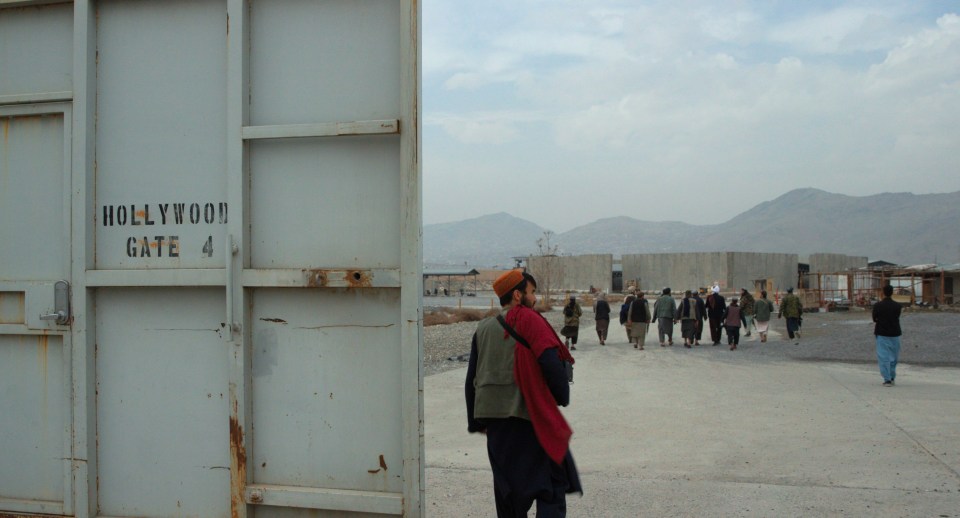 a group of people walking in front of a gate that says hollywood gate 4