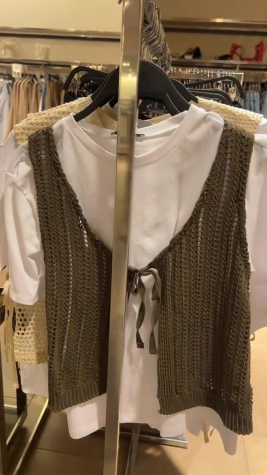 a knitted vest with a white shirt underneath it