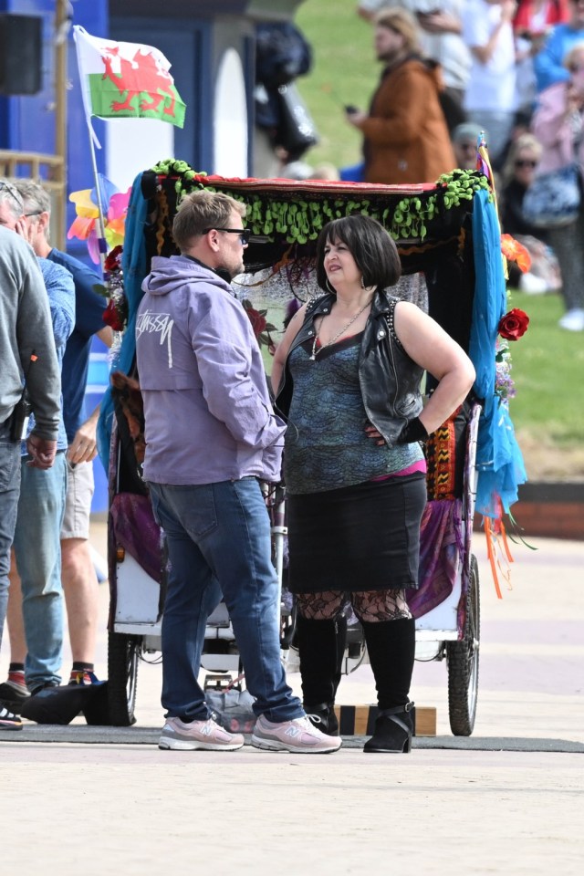 a man wearing a stussy hoodie stands next to a woman