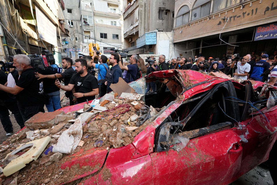 Rubble over a destroyed car following an airstrike