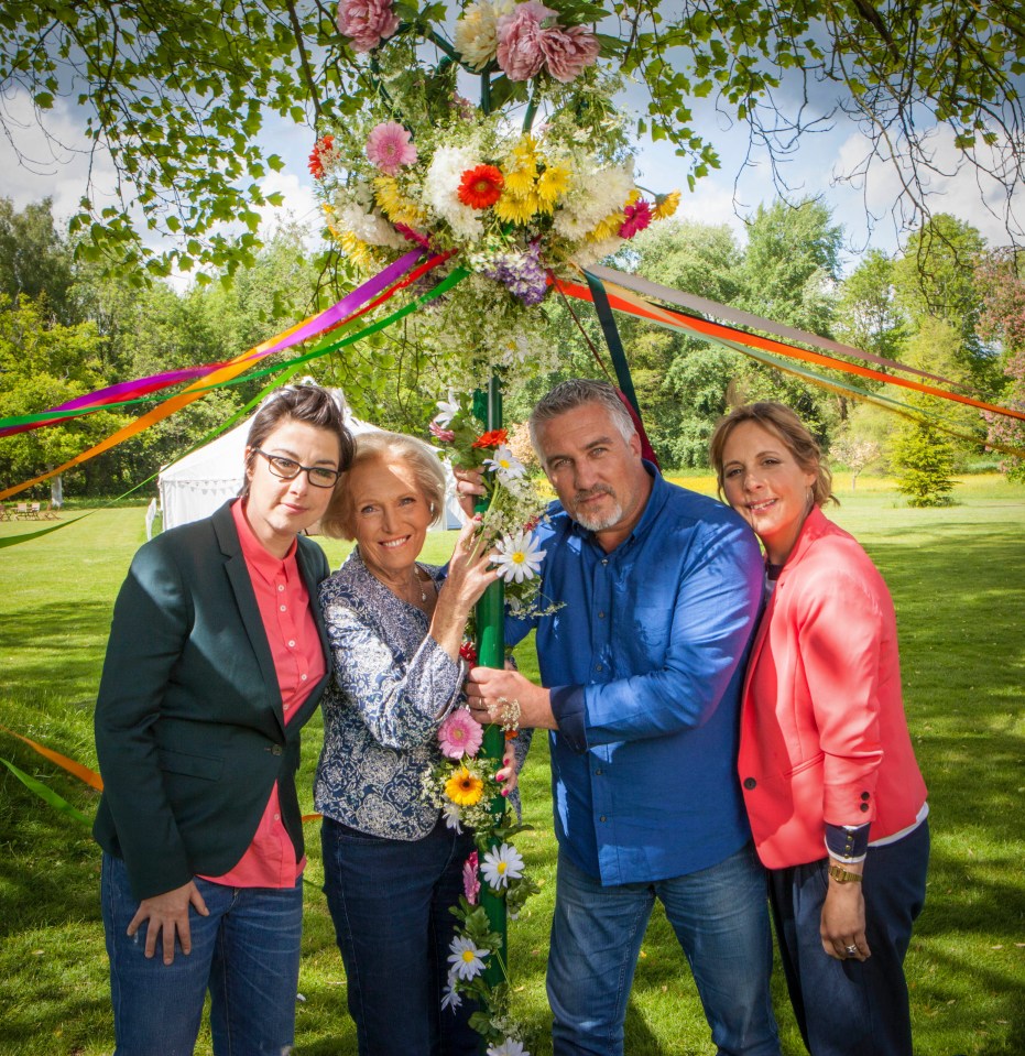 a group of people posing for a picture with flowers and ribbons