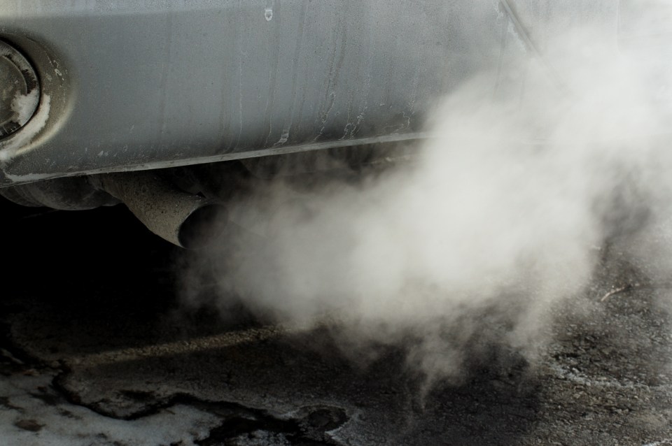 smoke is coming out of the exhaust pipe of a car