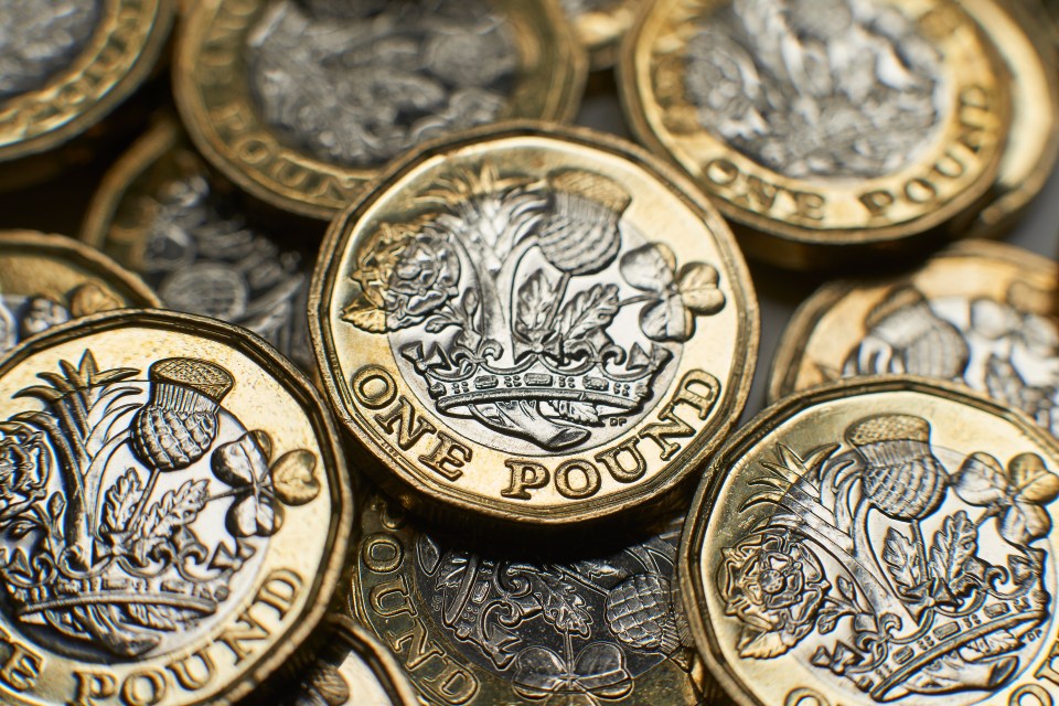 several one pound coins are stacked on top of each other