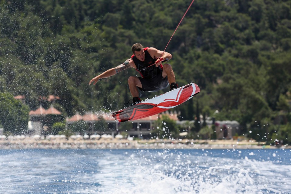 a man is riding a wakeboard in the water