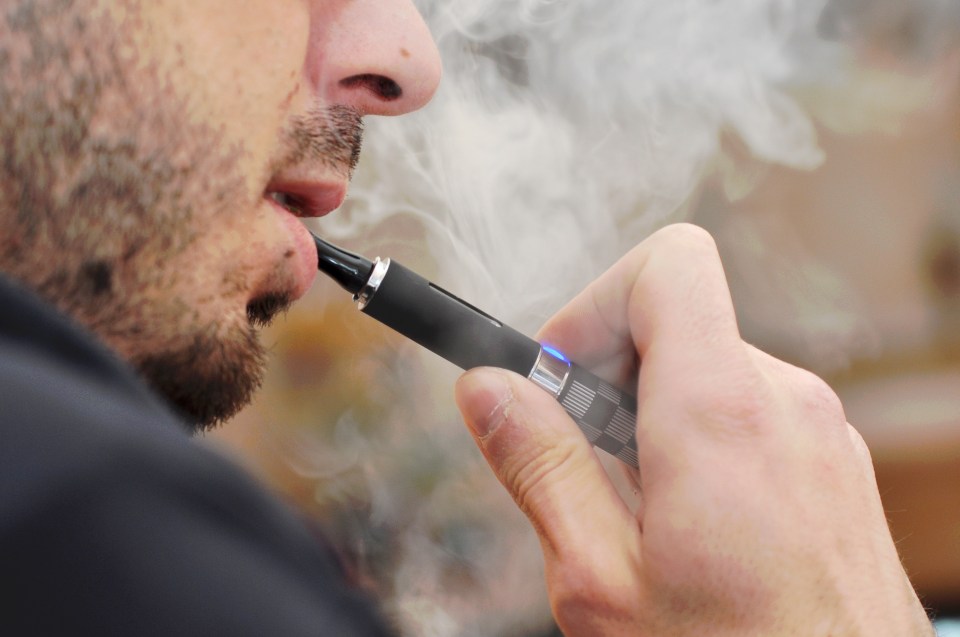 Man vaping an e-cigarette.