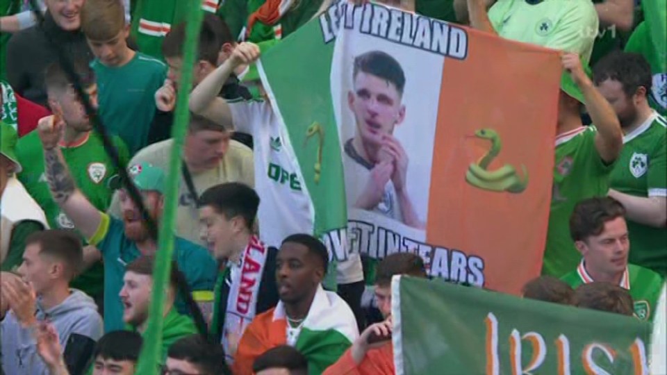 a group of people holding a sign that says ireland