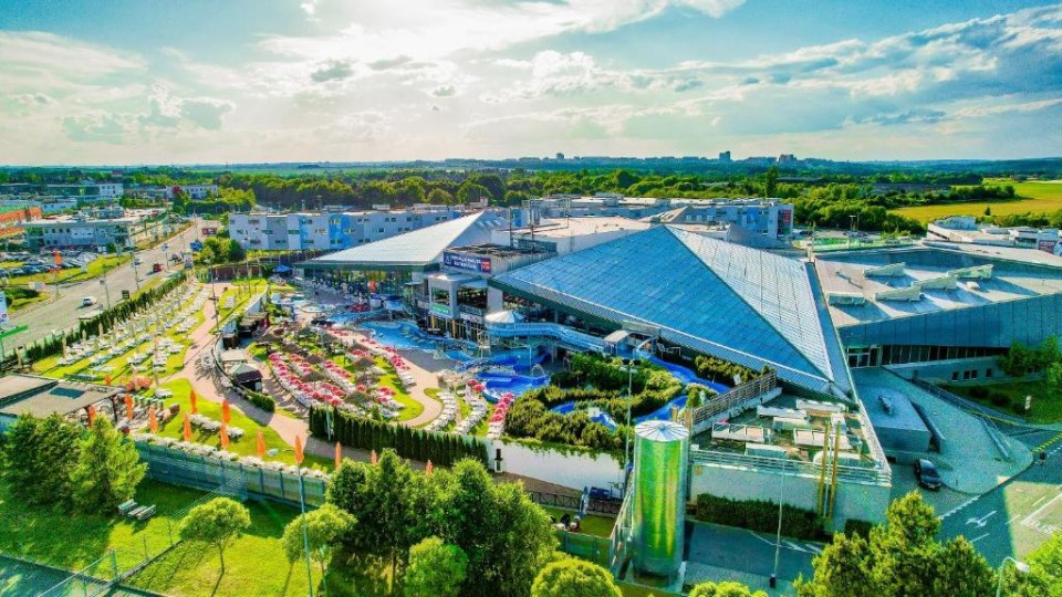 an aerial view of a large building with a pyramid shaped roof