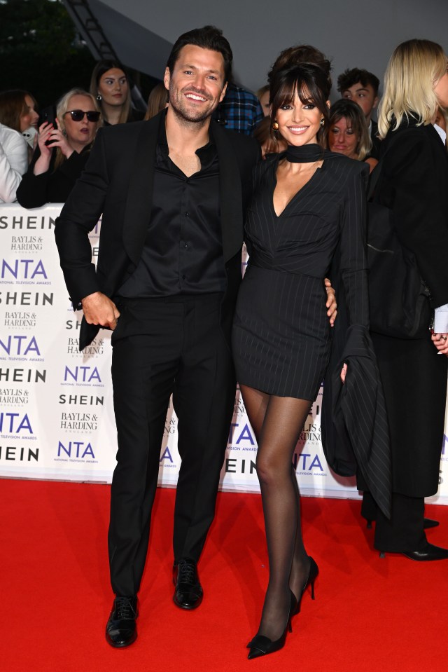 a man and a woman pose for a picture on a red carpet that says shein