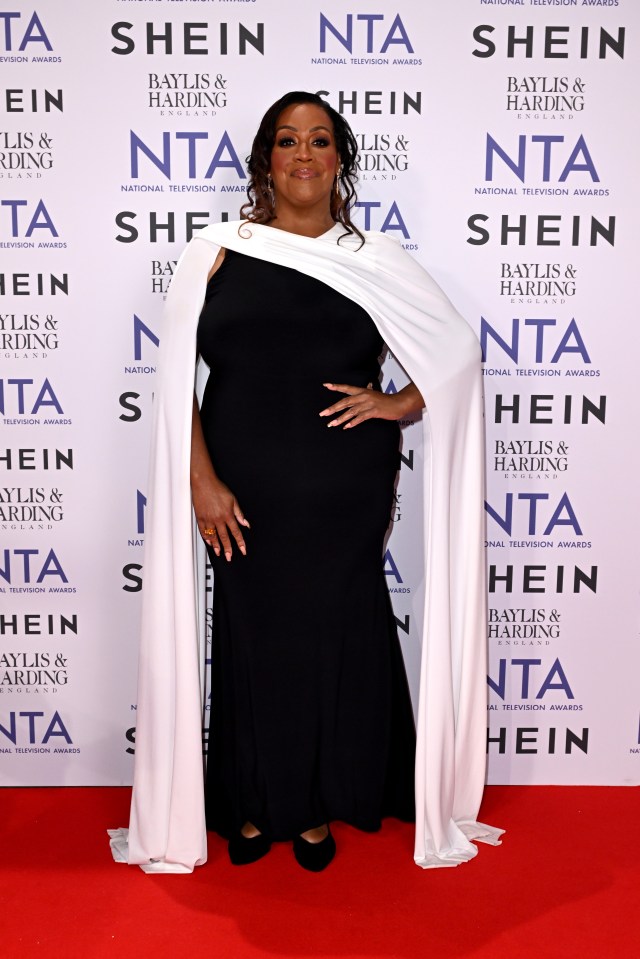 a woman stands in front of a wall that says shein on it