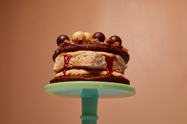 a cake on a green stand that looks like a hamburger