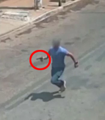 a man running down a street with a red circle around his hand